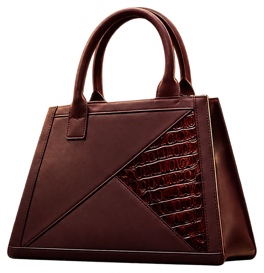 The Shoppé handbag presented on its own in the dark: burgundy panels, a single diagonal seam, a textured inset and rounded double handles.